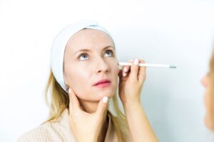 Woman having her face be examined