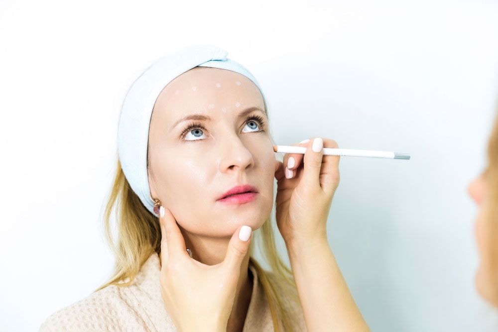 Woman having her face be examined