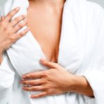 Close-up of the upper torso of a woman wearing a white bathrobe