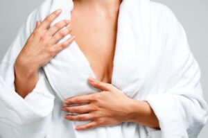 Close-up of the upper torso of a woman wearing a white bathrobe