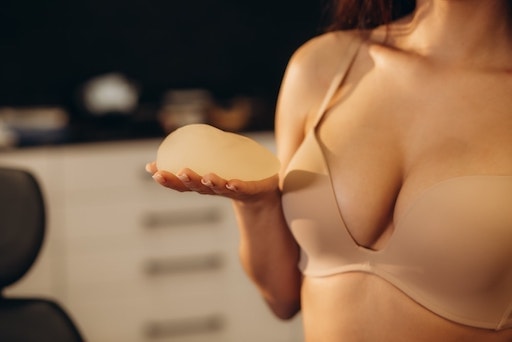 Female holding Breast Implant