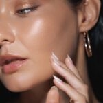 Woman touching cheek